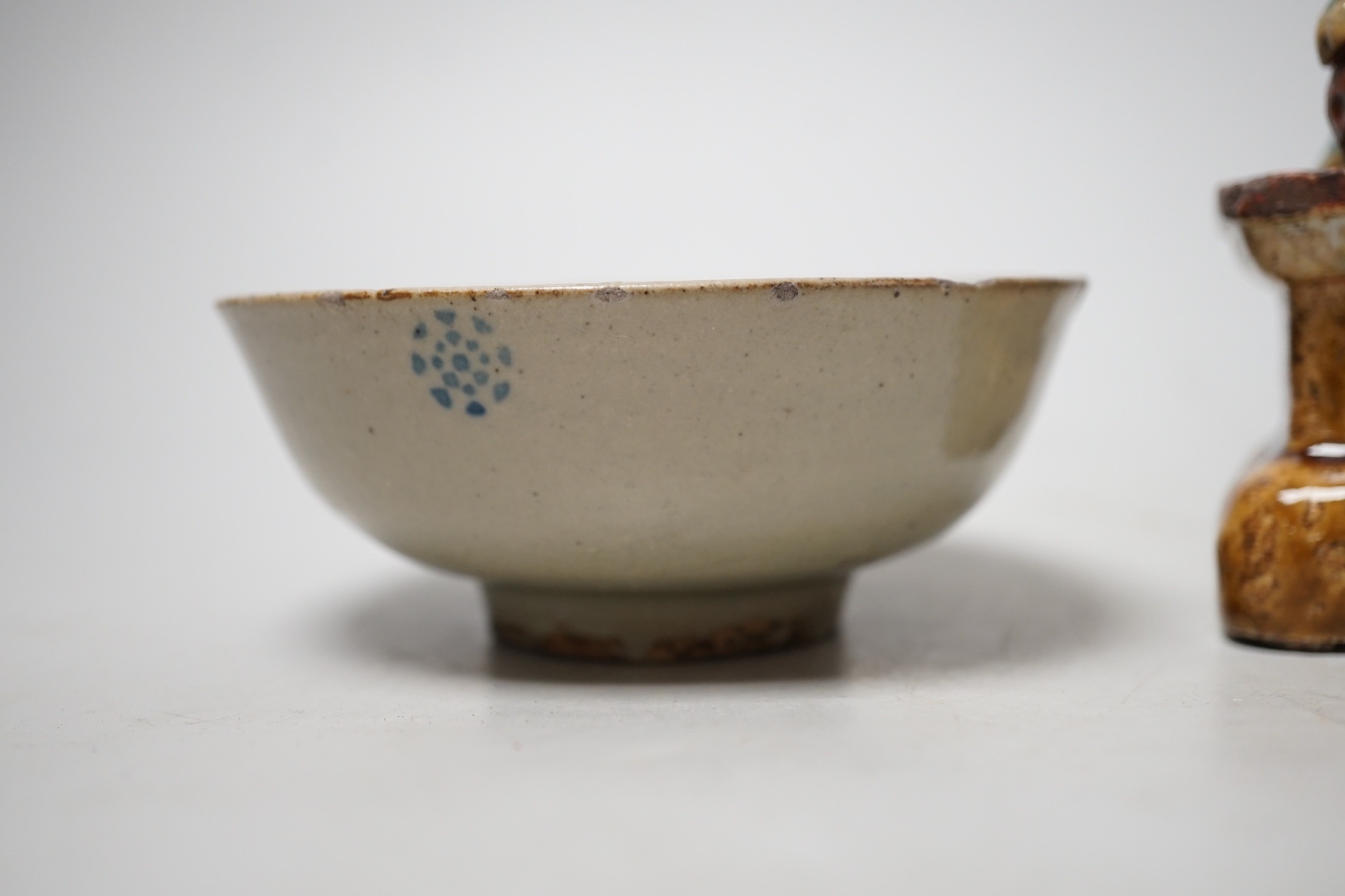 A 19th century Chinese Shiwan figure of a lion-dog and celadon glazed shallow bowl. Tallest 14cm
